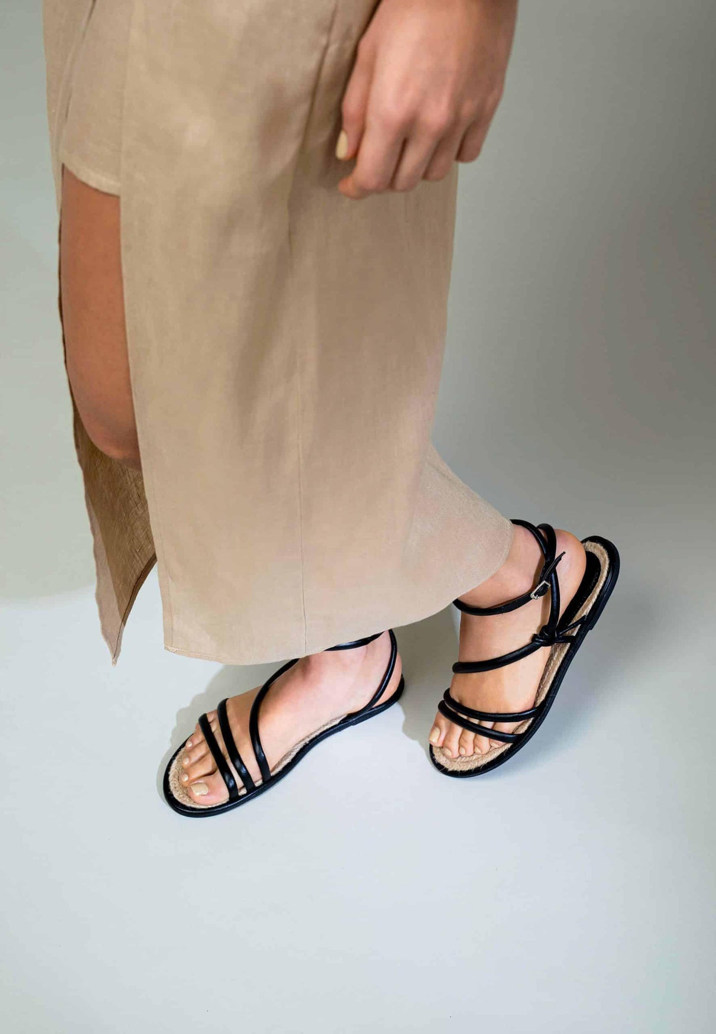 Lady wearing Ladies Flat Black Leather Sandals